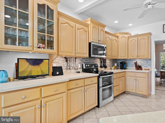 kitchen with light brown cabinetry, light tile patterned floors, decorative backsplash, and appliances with stainless steel finishes