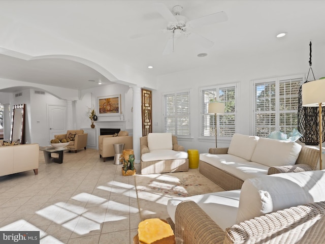 living room with ceiling fan and light tile patterned flooring