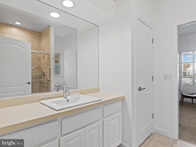 bathroom featuring vanity, tile patterned floors, and a shower with shower door