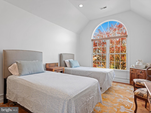 bedroom with light hardwood / wood-style flooring and vaulted ceiling