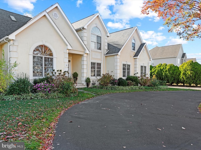 9 Glade Farm Dr, Rehoboth Beach, DE 19971 - traditional home with stucco siding and roof with shingles
