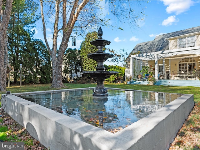 view of pool featuring a yard