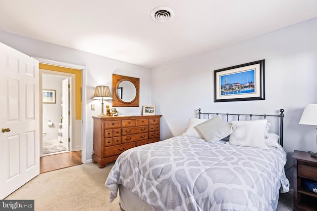 bedroom featuring carpet and ensuite bath