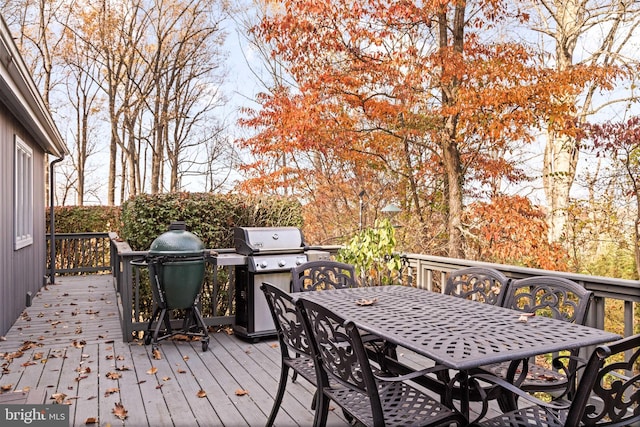 wooden terrace featuring a grill