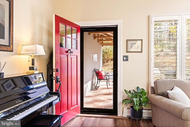 entryway featuring dark hardwood / wood-style flooring and a baseboard heating unit