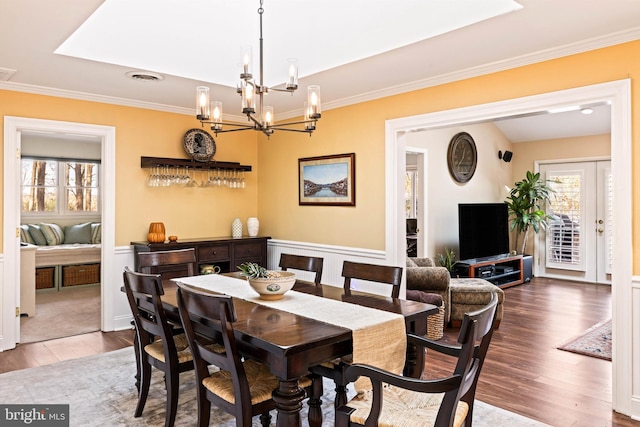 dining room with hardwood / wood-style floors and crown molding