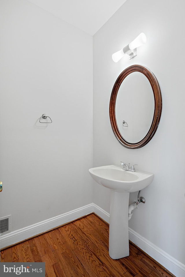 bathroom with hardwood / wood-style flooring