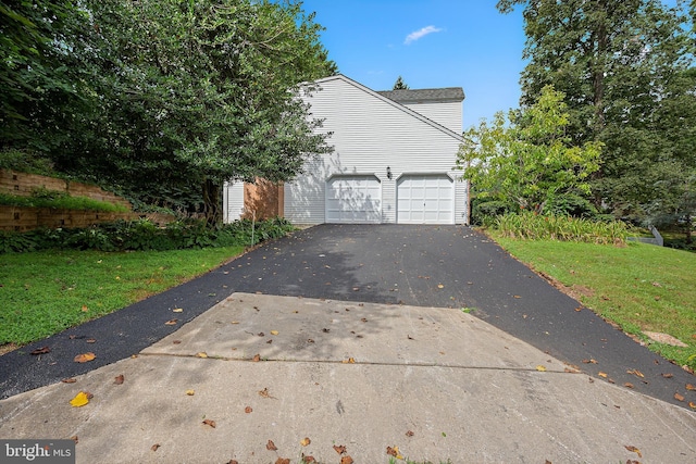 view of property exterior featuring a garage and a yard