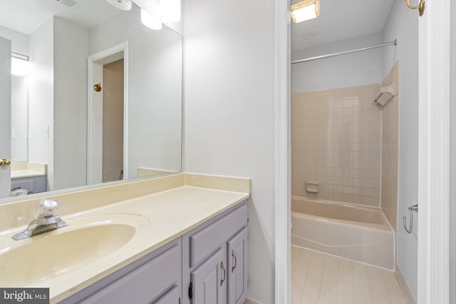 bathroom with vanity, tile patterned floors, and tiled shower / bath