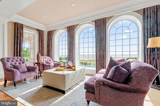 interior space with ornamental molding and hardwood / wood-style flooring