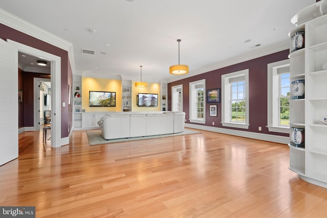 unfurnished living room featuring built in features, crown molding, and light hardwood / wood-style floors