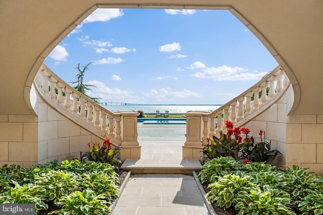 view of property's community featuring a swimming pool and a water view