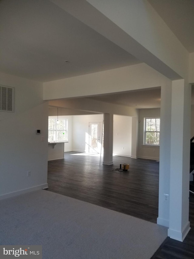 unfurnished living room with dark hardwood / wood-style flooring