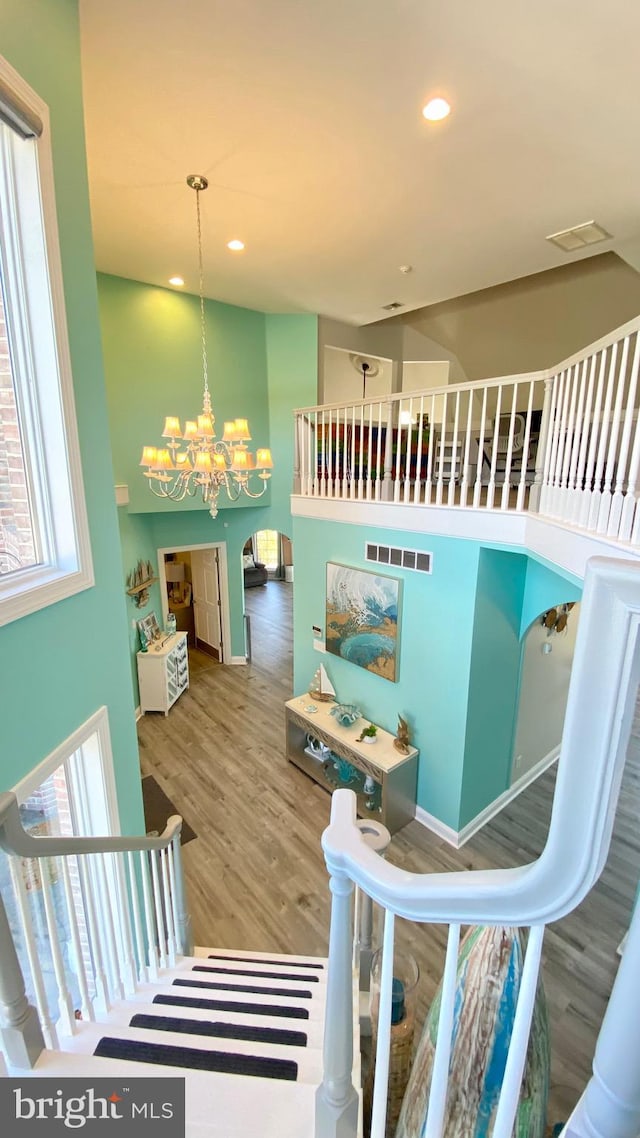 interior space featuring hardwood / wood-style flooring and a notable chandelier