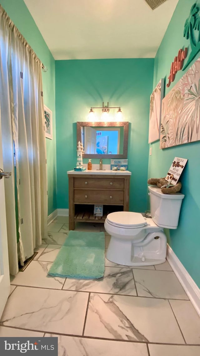 bathroom with vanity and toilet