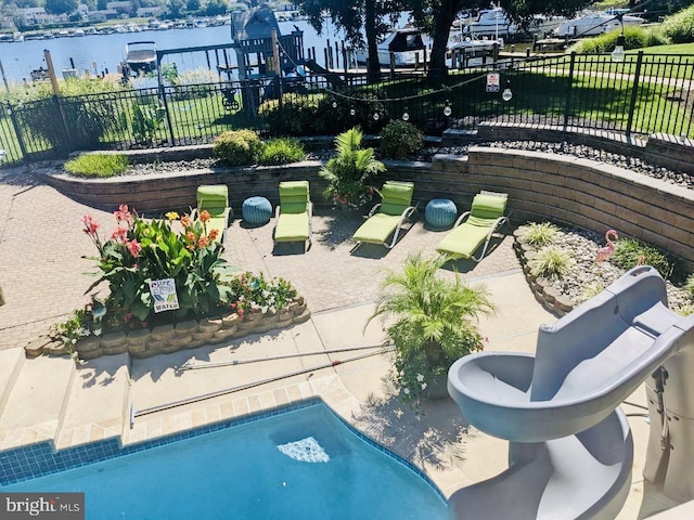 view of community with a water view, a pool, and a patio area