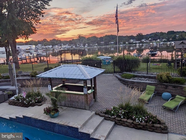 exterior space with a patio and a water view