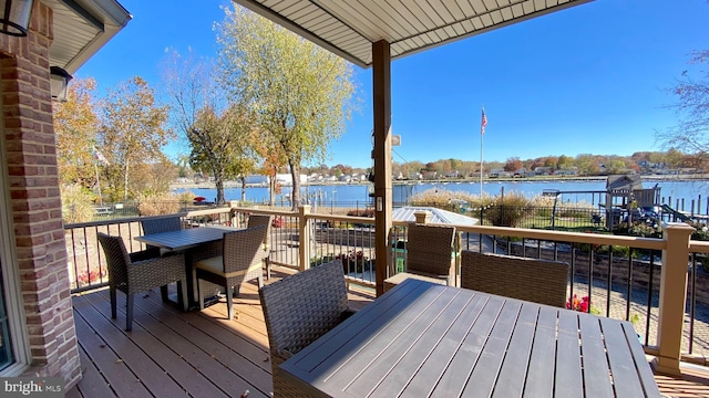 wooden terrace featuring a water view