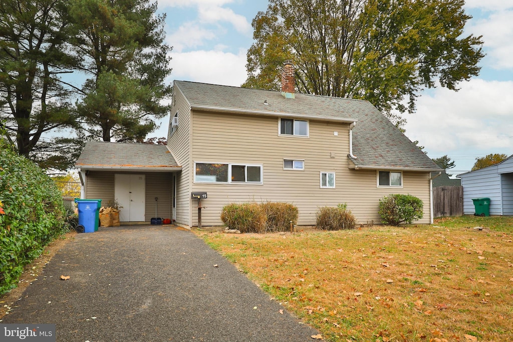 back of property featuring a yard