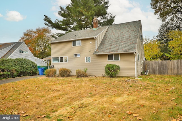 rear view of house featuring a lawn