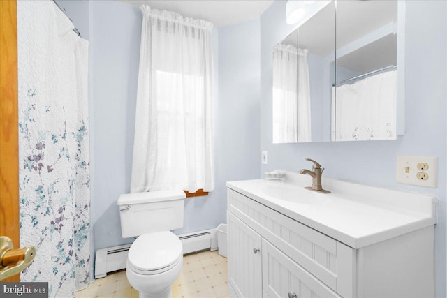 bathroom featuring a healthy amount of sunlight, vanity, a baseboard radiator, and toilet