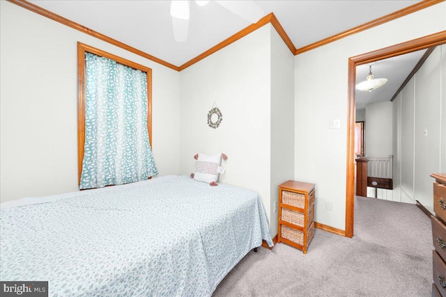 bedroom with carpet flooring, ceiling fan, and ornamental molding