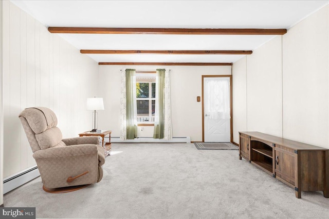 sitting room featuring baseboard heating, wood walls, beamed ceiling, and light colored carpet