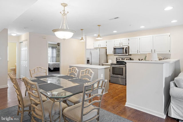 dining space with dark hardwood / wood-style floors