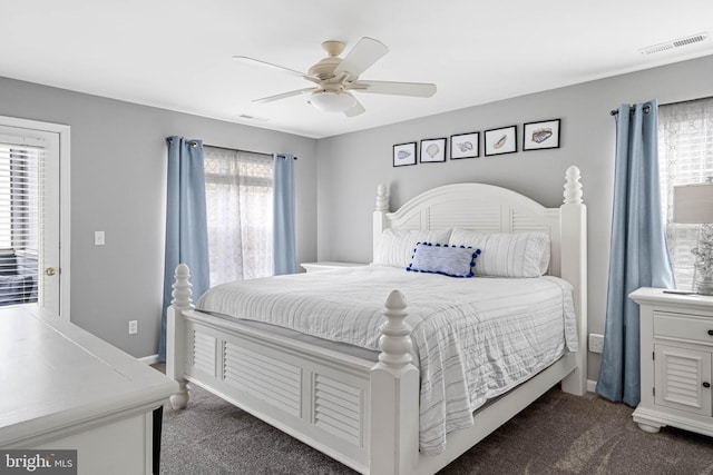 carpeted bedroom featuring ceiling fan and multiple windows