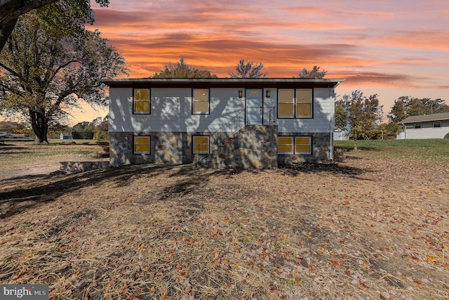 view of back house at dusk