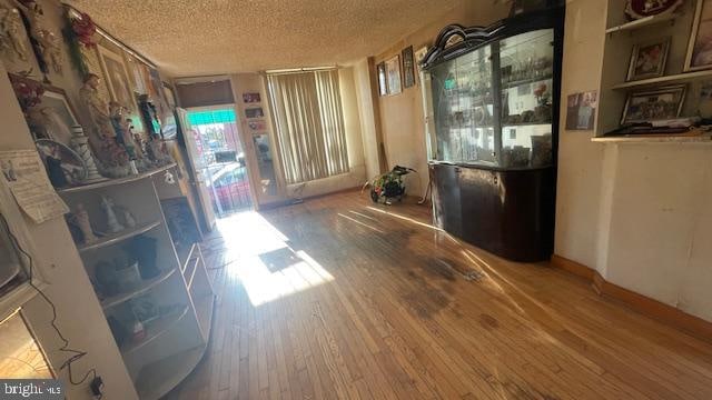 interior space featuring hardwood / wood-style floors and a textured ceiling