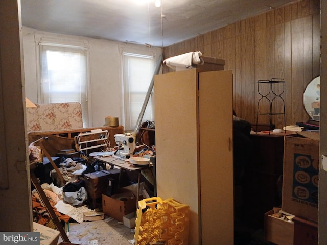 bedroom featuring wood walls