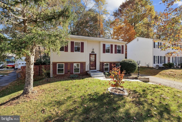 bi-level home with a front lawn