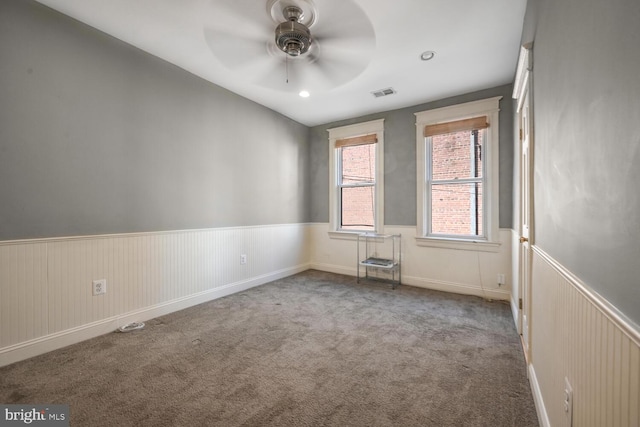 empty room featuring carpet and ceiling fan