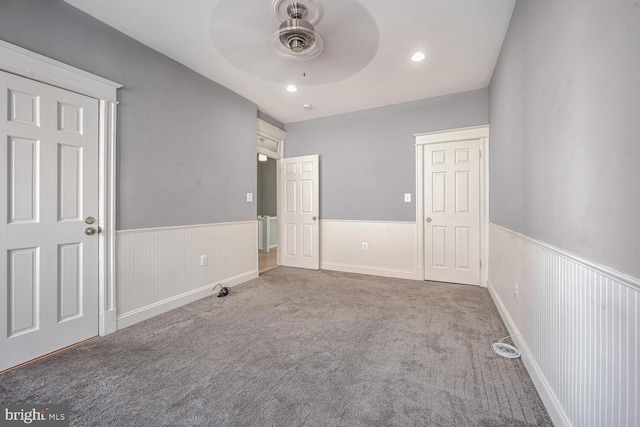 unfurnished bedroom featuring ceiling fan and carpet flooring