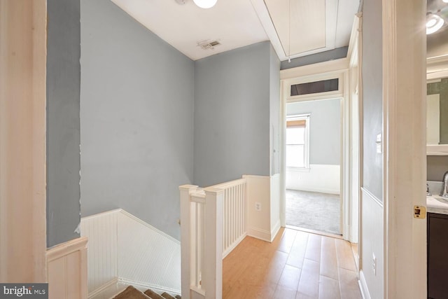 corridor with light wood-type flooring