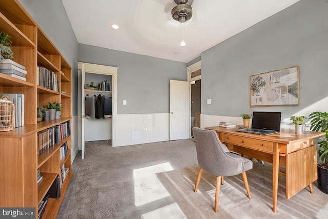 carpeted home office with ceiling fan