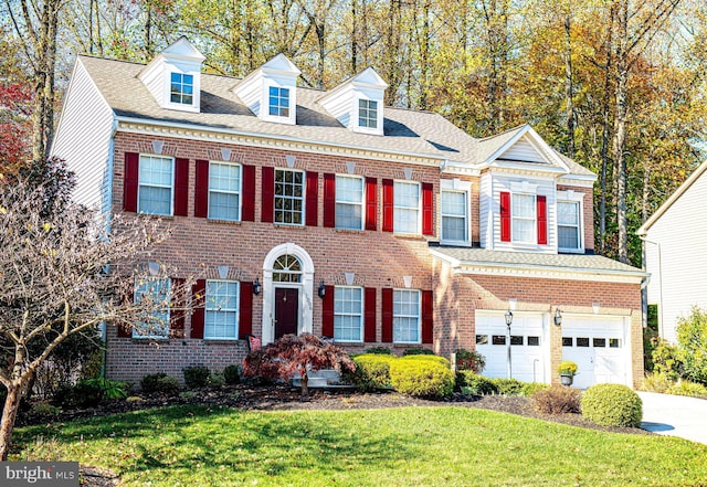 view of front of home featuring a garage and a front lawn