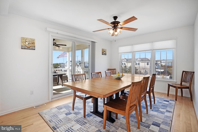 dining space featuring ceiling fan and light wood-type flooring