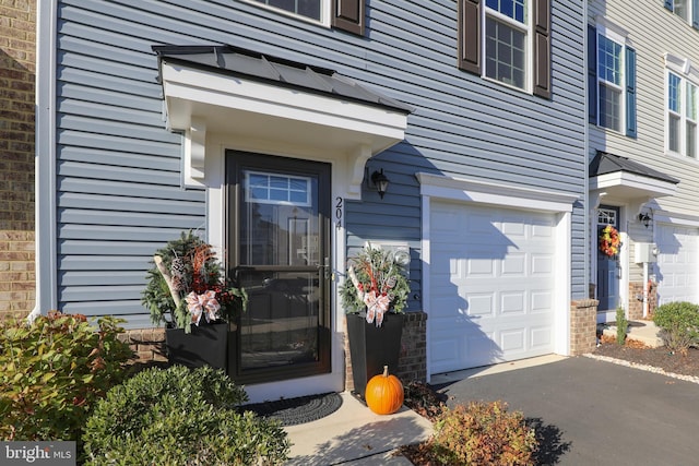 view of exterior entry with a garage