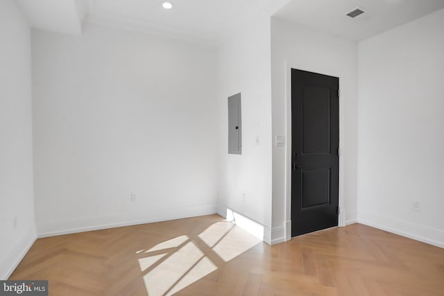 spare room with light parquet flooring and electric panel