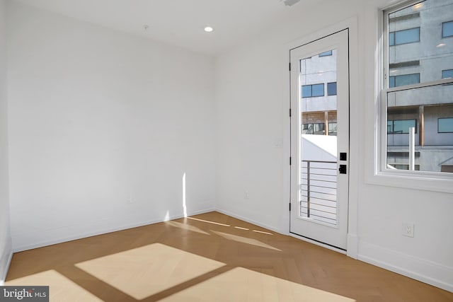 doorway to outside featuring parquet floors