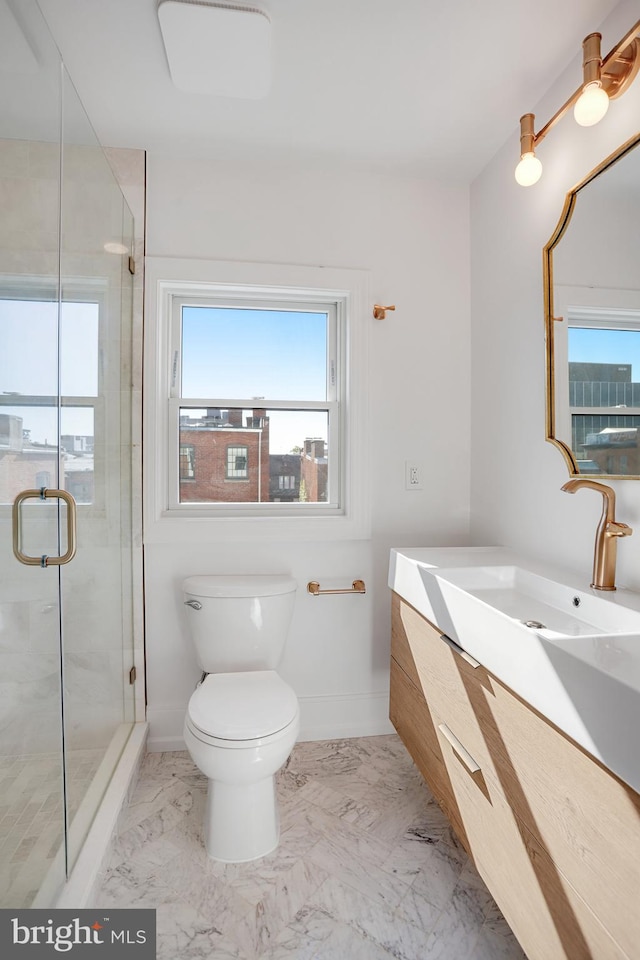 bathroom with walk in shower, vanity, and toilet