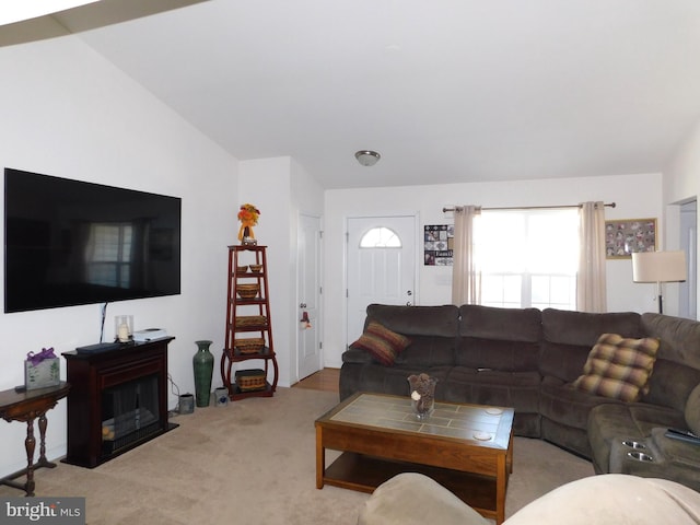 carpeted living room with lofted ceiling