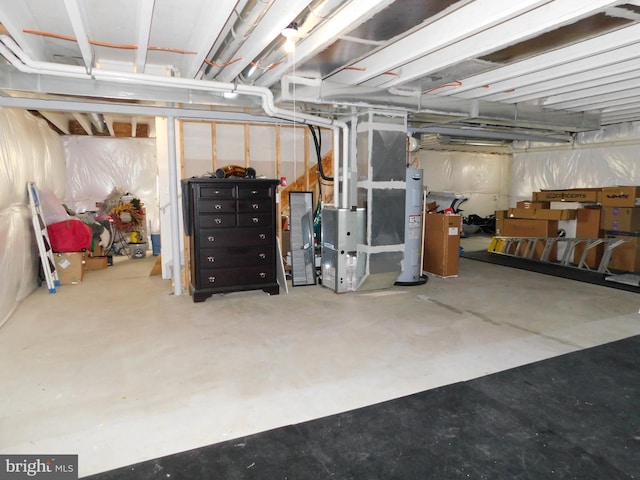 basement featuring water heater and heating unit