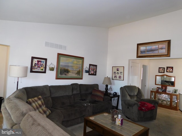 carpeted living room with lofted ceiling