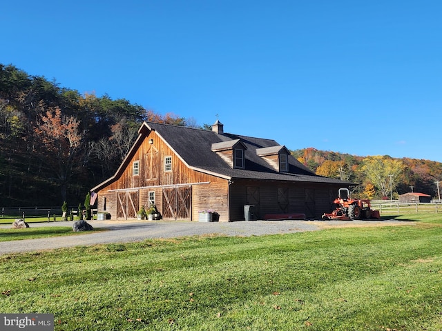 view of property exterior with a garage and a lawn