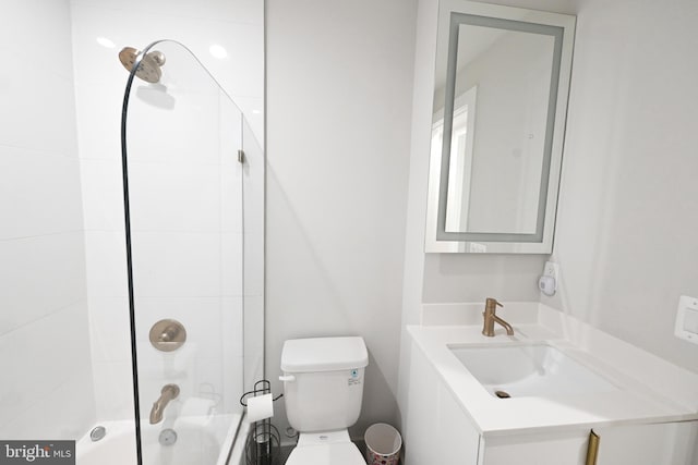 full bathroom featuring toilet, vanity, and tiled shower / bath