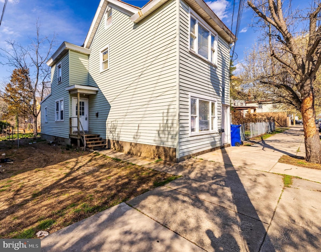 214 E Broad St, Millville, NJ 08332 - view of side of home featuring driveway and fence