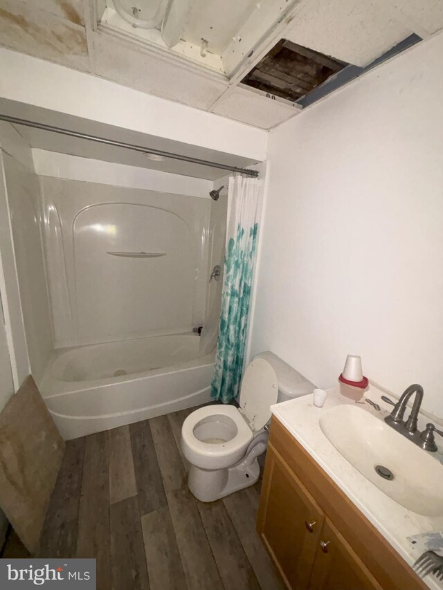 full bathroom with toilet, shower / tub combo with curtain, vanity, and hardwood / wood-style floors